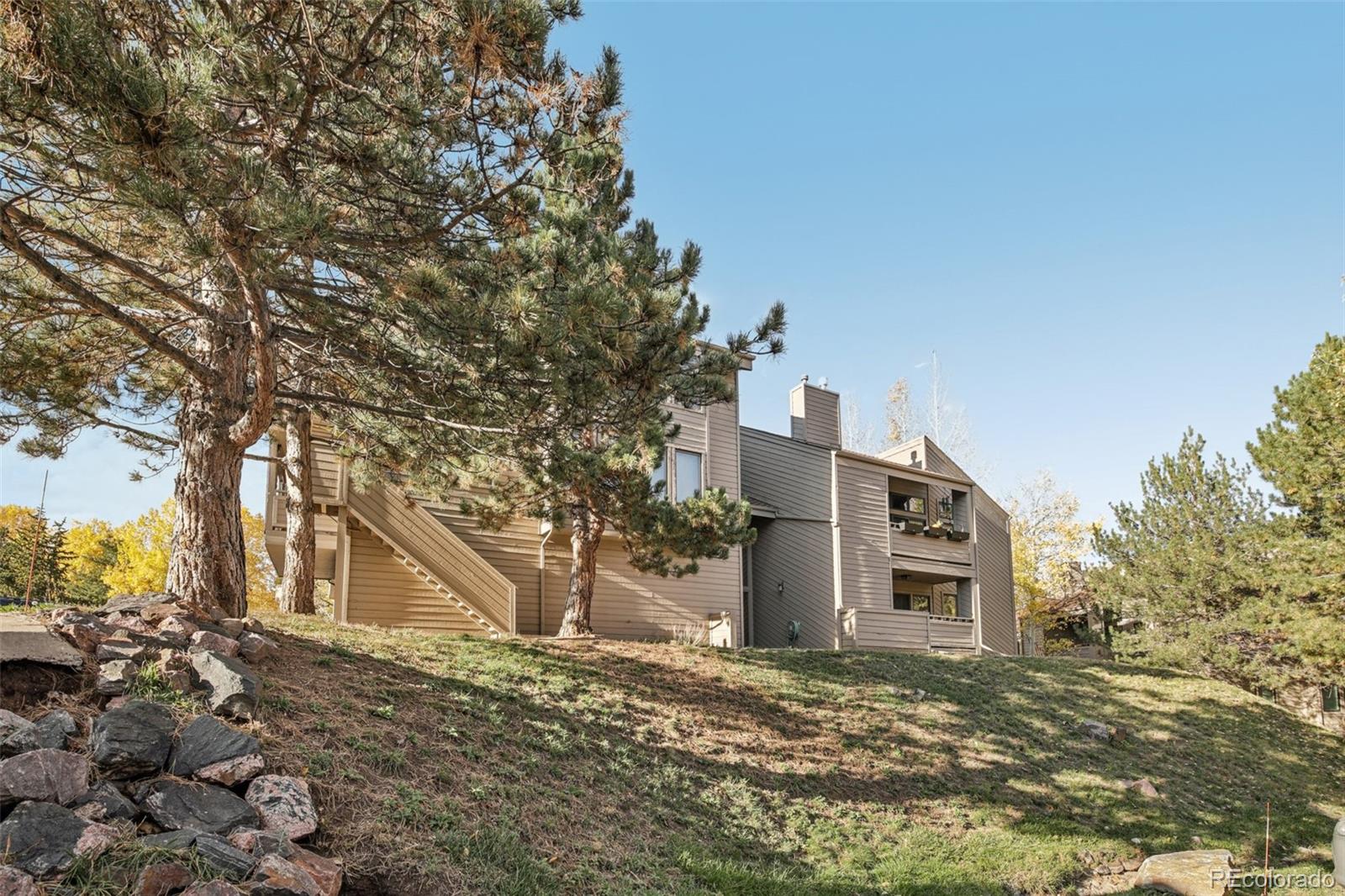 23674 Pondview Place, Unit B Golden, CO 80401 - Photo 24 of 35 a tall building with large trees