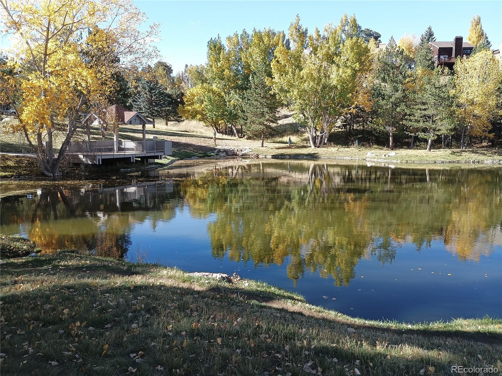 23674 Pondview Place, Unit B Golden, CO 80401 - Photo 27 of 35 a view of a lake with trees by side of it