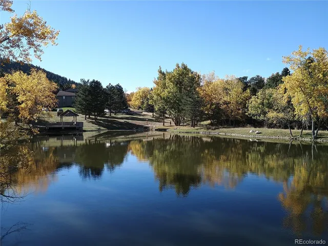 a view of a lake with a yard and sitting area