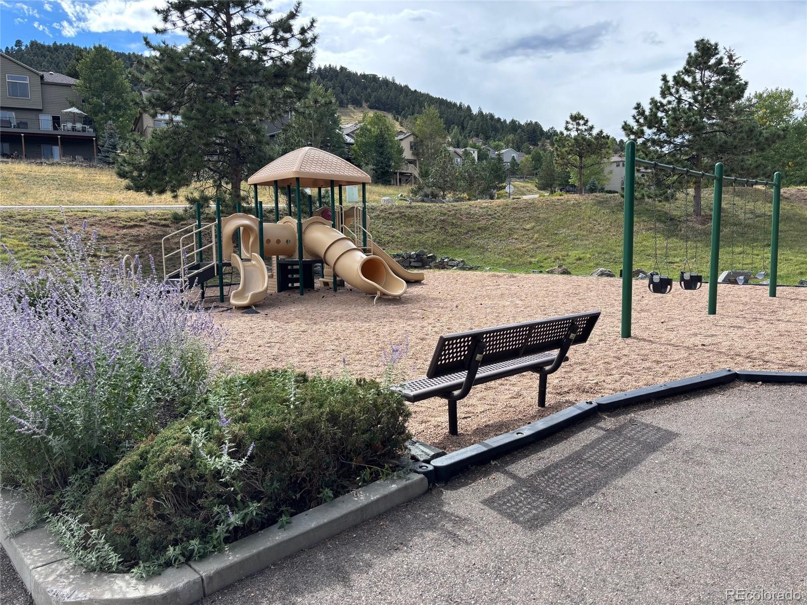 23674 Pondview Place, Unit B Golden, CO 80401 - Photo 31 of 35 a view of a lake with a yard and sitting area
