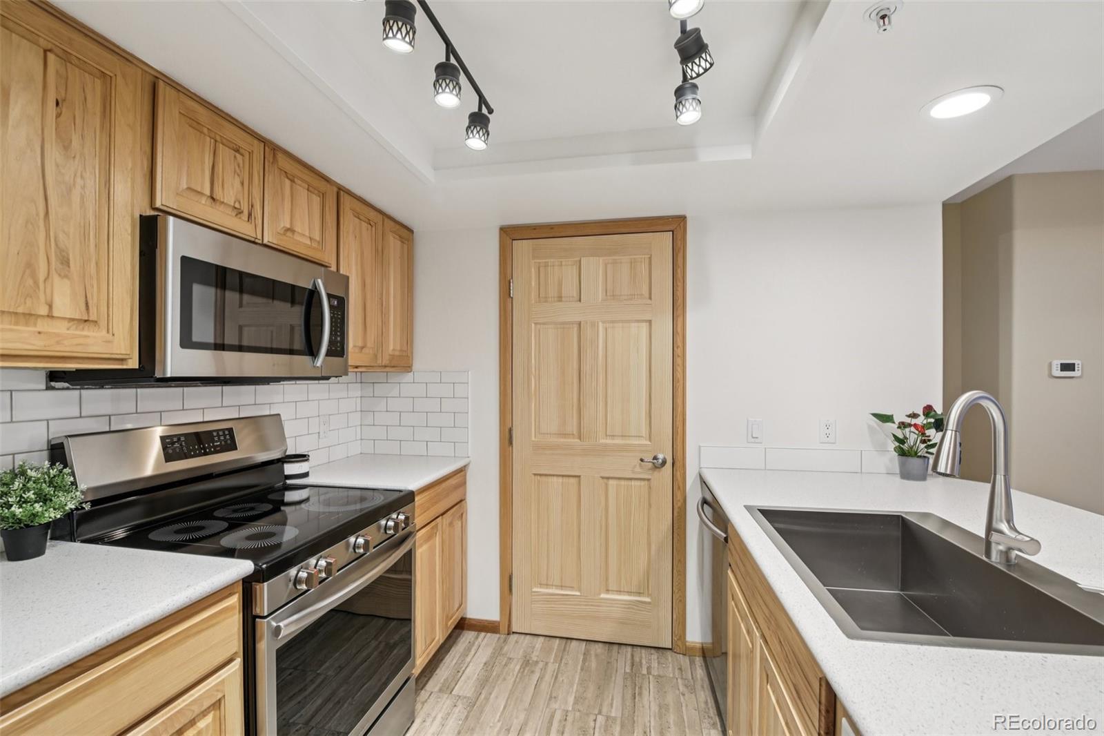 23674 Pondview Place, Unit B Golden, CO 80401 - Photo 7 of 35 a kitchen that has a sink and a stove top oven