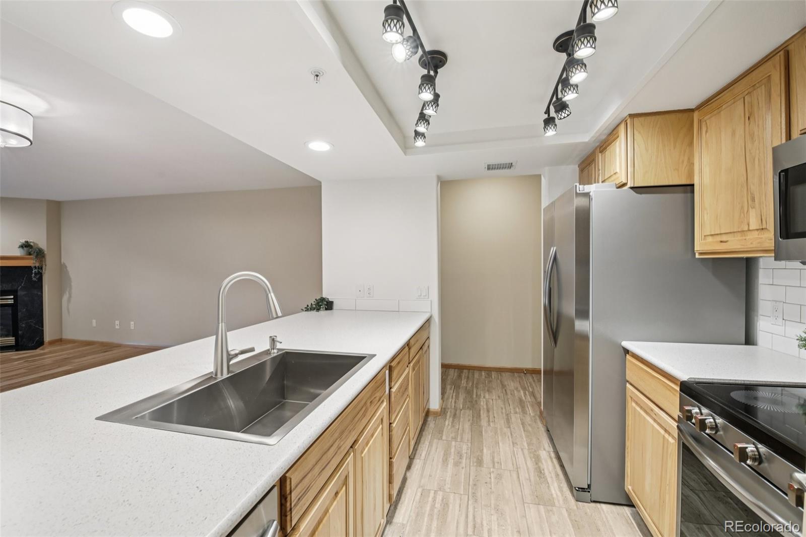 23674 Pondview Place, Unit B Golden, CO 80401 - Photo 9 of 35 a kitchen that has a sink a refrigerator and cabinets