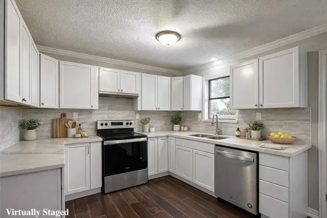 a kitchen with a sink stove and cabinets