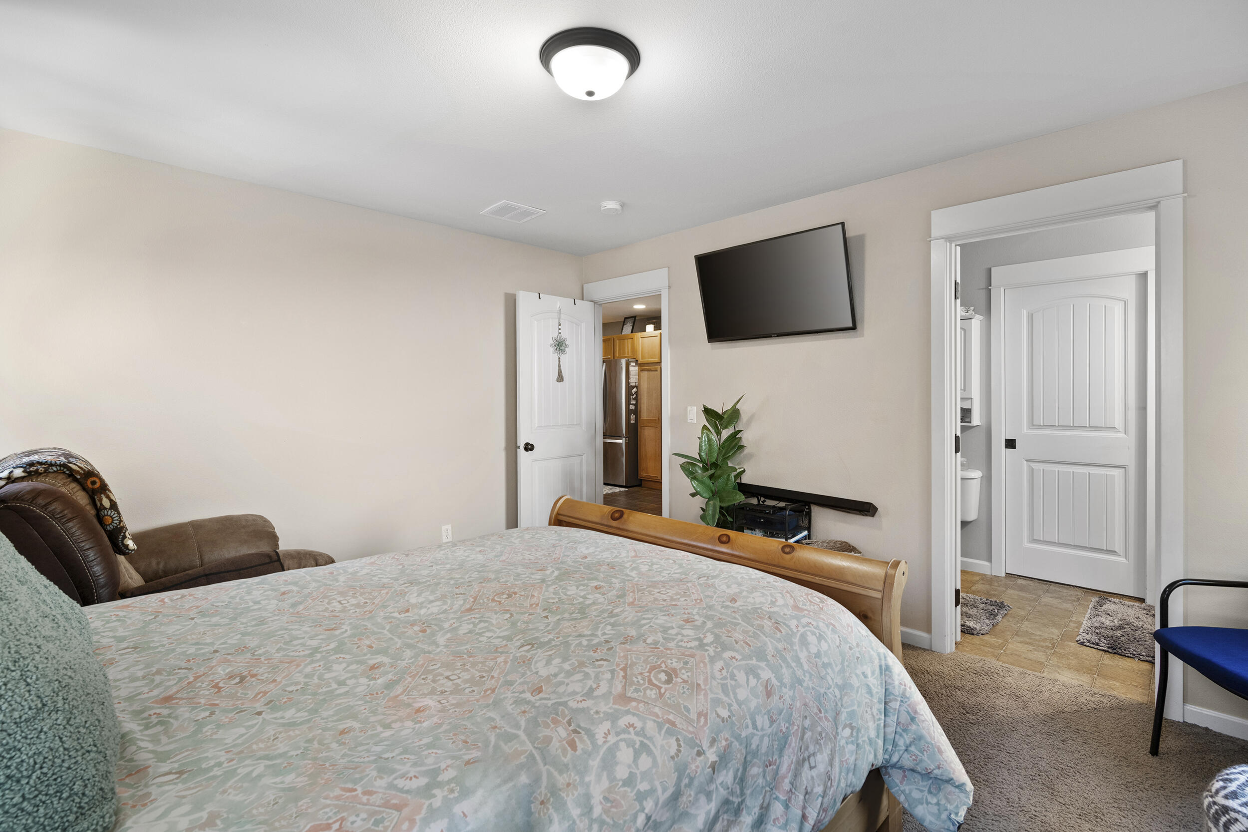 62906 Bilyeu Way Bend, OR 97701 - Photo 65 of 100 a bedroom with a bed and a flat screen tv