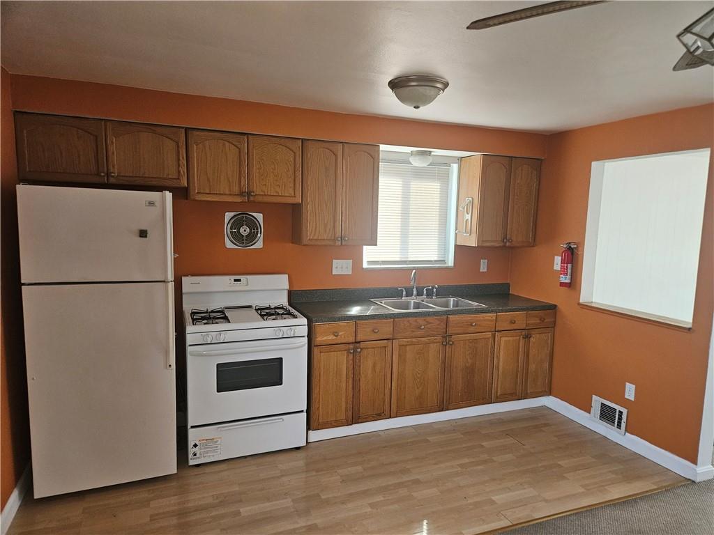 812 Westbury Road, Unit B North Versailles, PA 15137 - Photo 11 of 29 a kitchen with granite countertop a stove a sink and a refrigerator