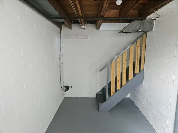 an empty room with a ceiling fan and entryway