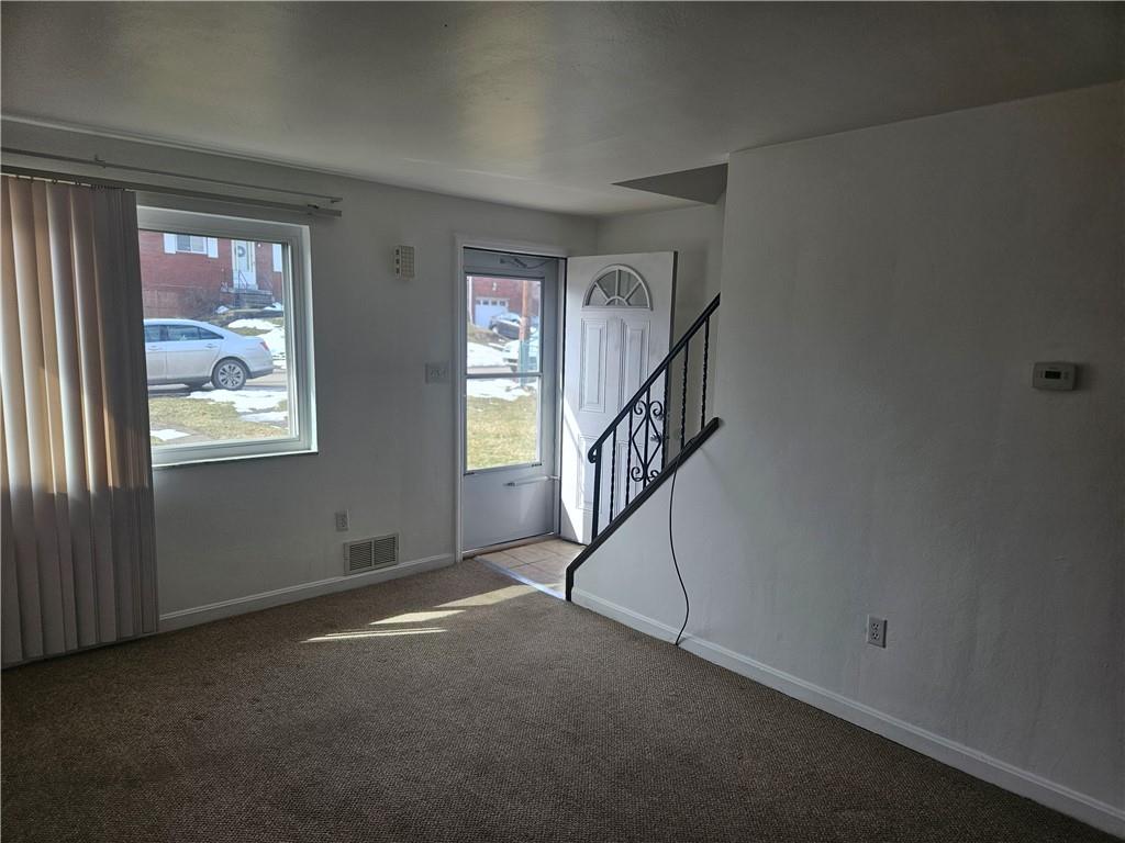 812 Westbury Road, Unit B North Versailles, PA 15137 - Photo 5 of 29 a view of an empty room with stairs and a window