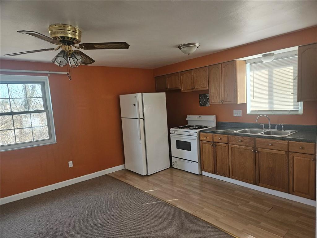 812 Westbury Road, Unit B North Versailles, PA 15137 - Photo 8 of 29 a kitchen with refrigerator cabinets and wooden floor