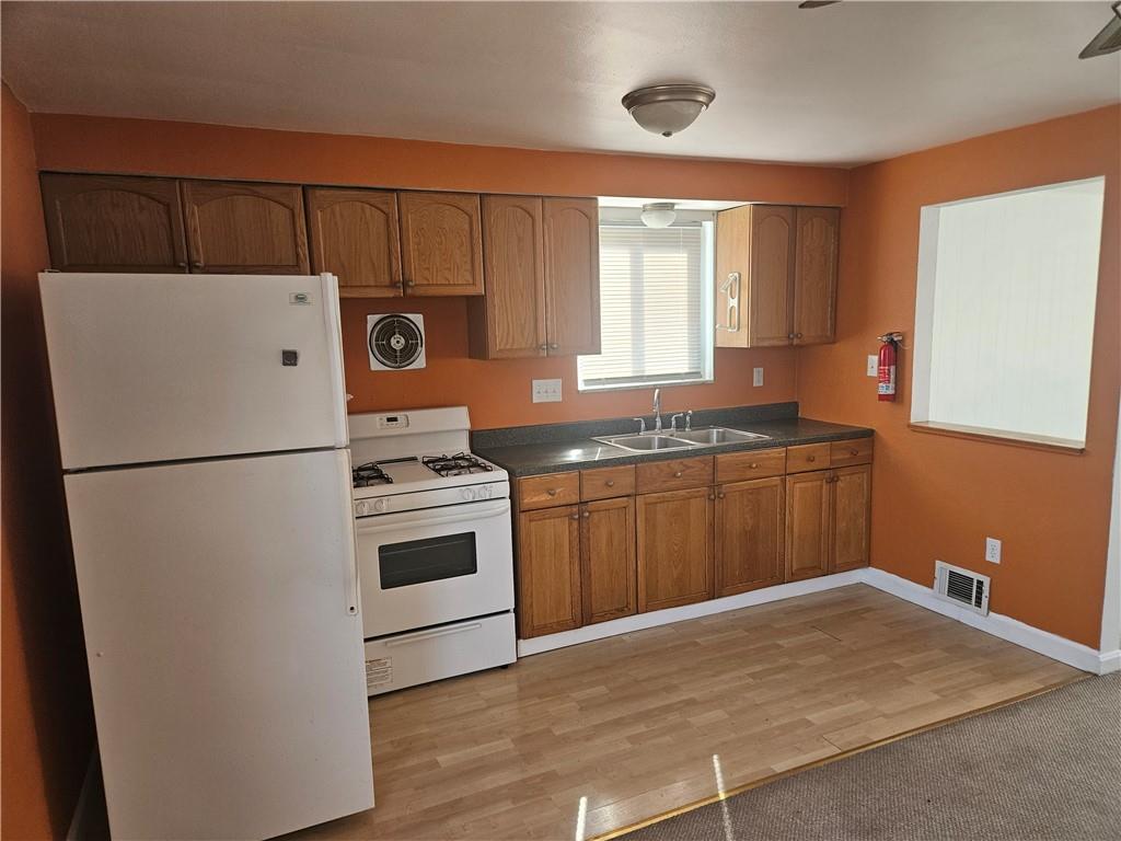 812 Westbury Road, Unit B North Versailles, PA 15137 - Photo 9 of 29 a kitchen with a refrigerator and a sink