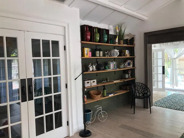 a view of living room with shelves and a book shelf