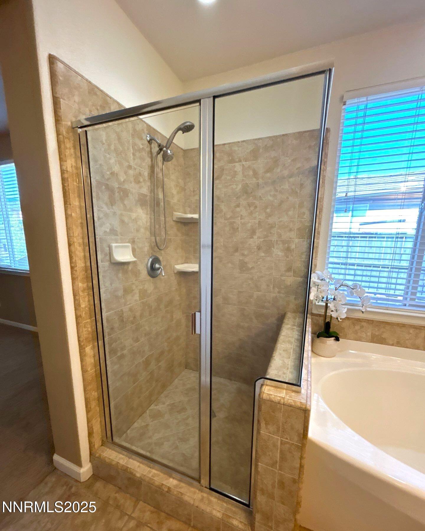 7150 Provence Circle Reno, NV 89523 - Photo 15 of 22 a bathroom with a shower and a bath tub