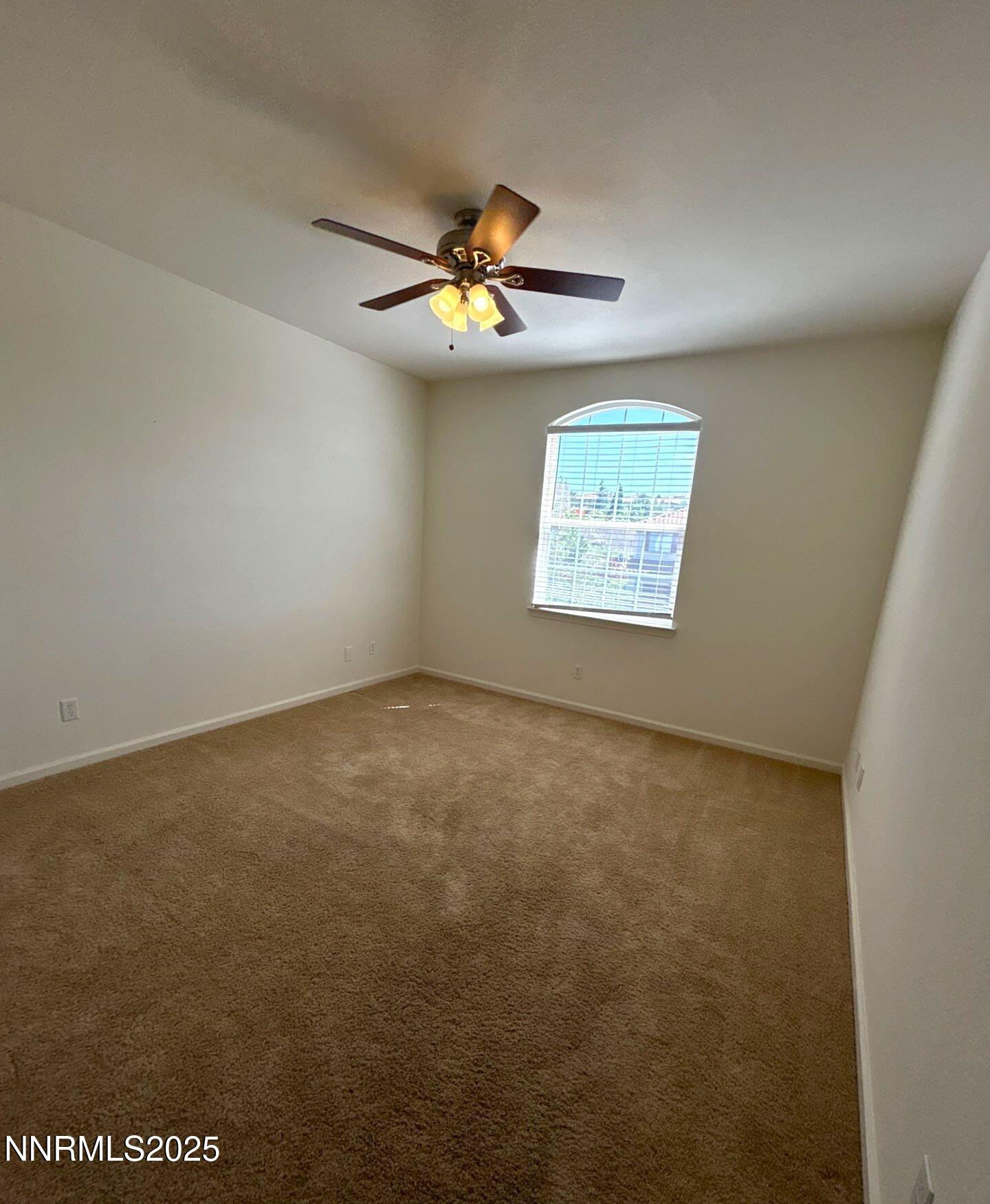 7150 Provence Circle Reno, NV 89523 - Photo 17 of 22 an empty room with windows and fan