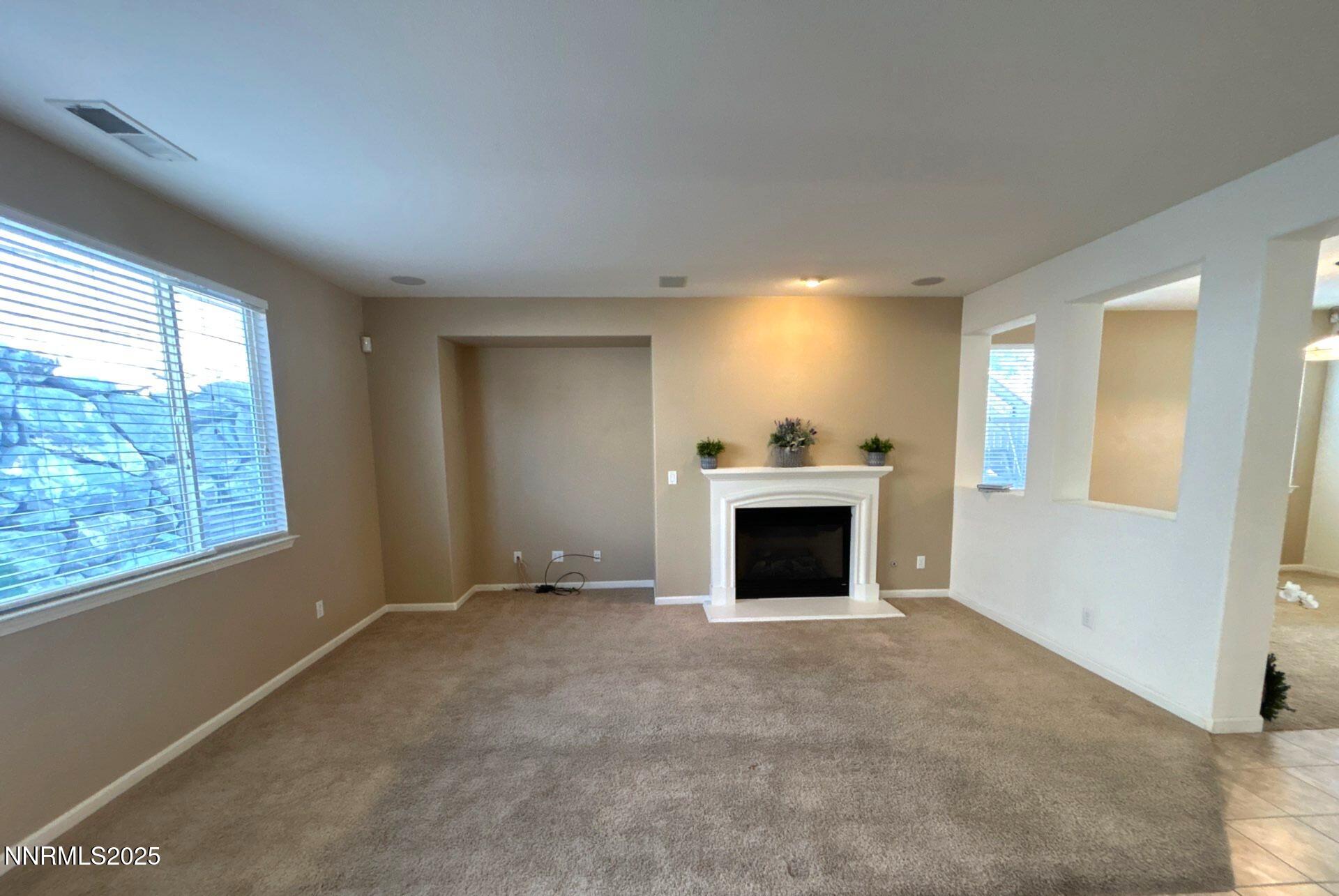 7150 Provence Circle Reno, NV 89523 - Photo 9 of 22 a view of an empty room with a window and fireplace
