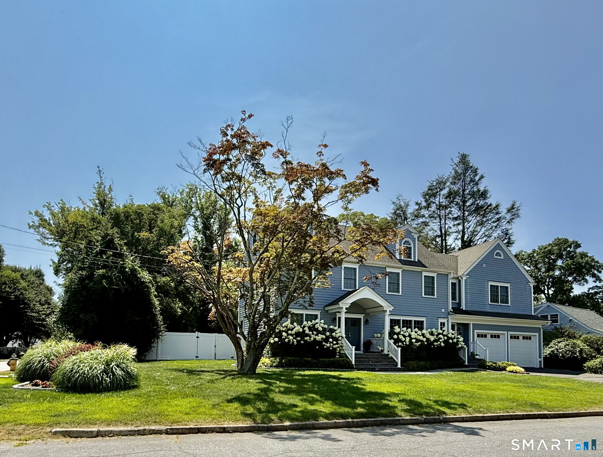 11 Tuckahoe Lane Fairfield, CT 06824 - Photo 1 of 1 a front view of a house with a yard and garage