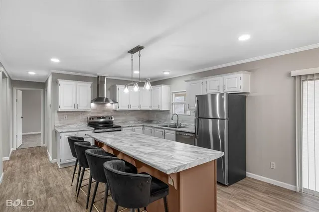 a kitchen with refrigerator and chairs