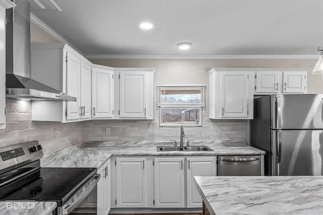 a kitchen with granite countertop a sink appliances and cabinets