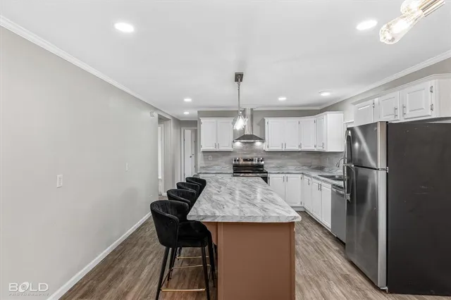 a kitchen with stainless steel appliances granite countertop a sink stove and cabinets