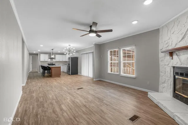 an empty room with fan and windows