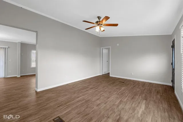 an empty room with closet and a chandelier fan