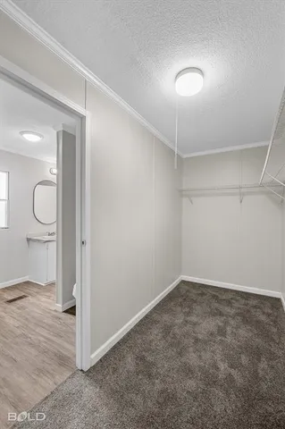 an empty room with ceiling fan and windows