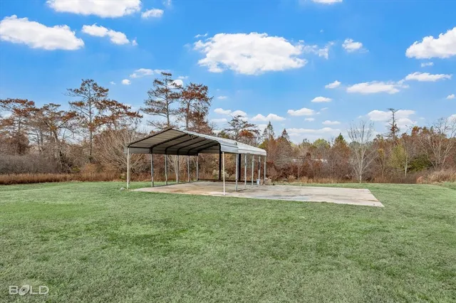 a kitchen with stainless steel appliances a table chairs refrigerator and wooden floor