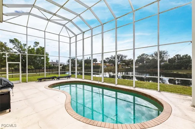 a view of a house with swimming pool and sitting area