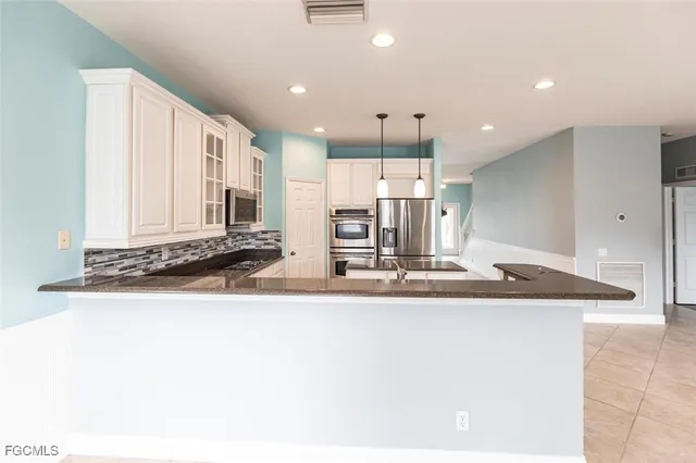 a view of a kitchen with a sink and wooden floor