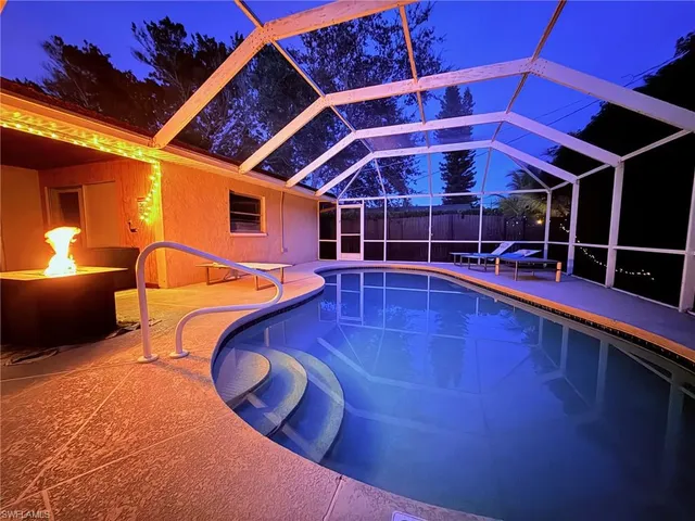 a view of a swimming pool with an outdoor seating