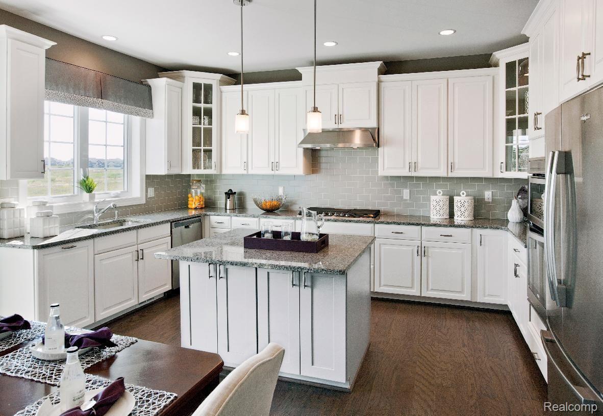 50639 Scarborough Road Canton, MI 48188 - Photo 4 of 12 Well-appointed kitchen includes Whirlpool® stainless steel appliances, Kohler® faucets, 42-inch wall cabinets, granite countertops, ceramic tile backsplash, and more