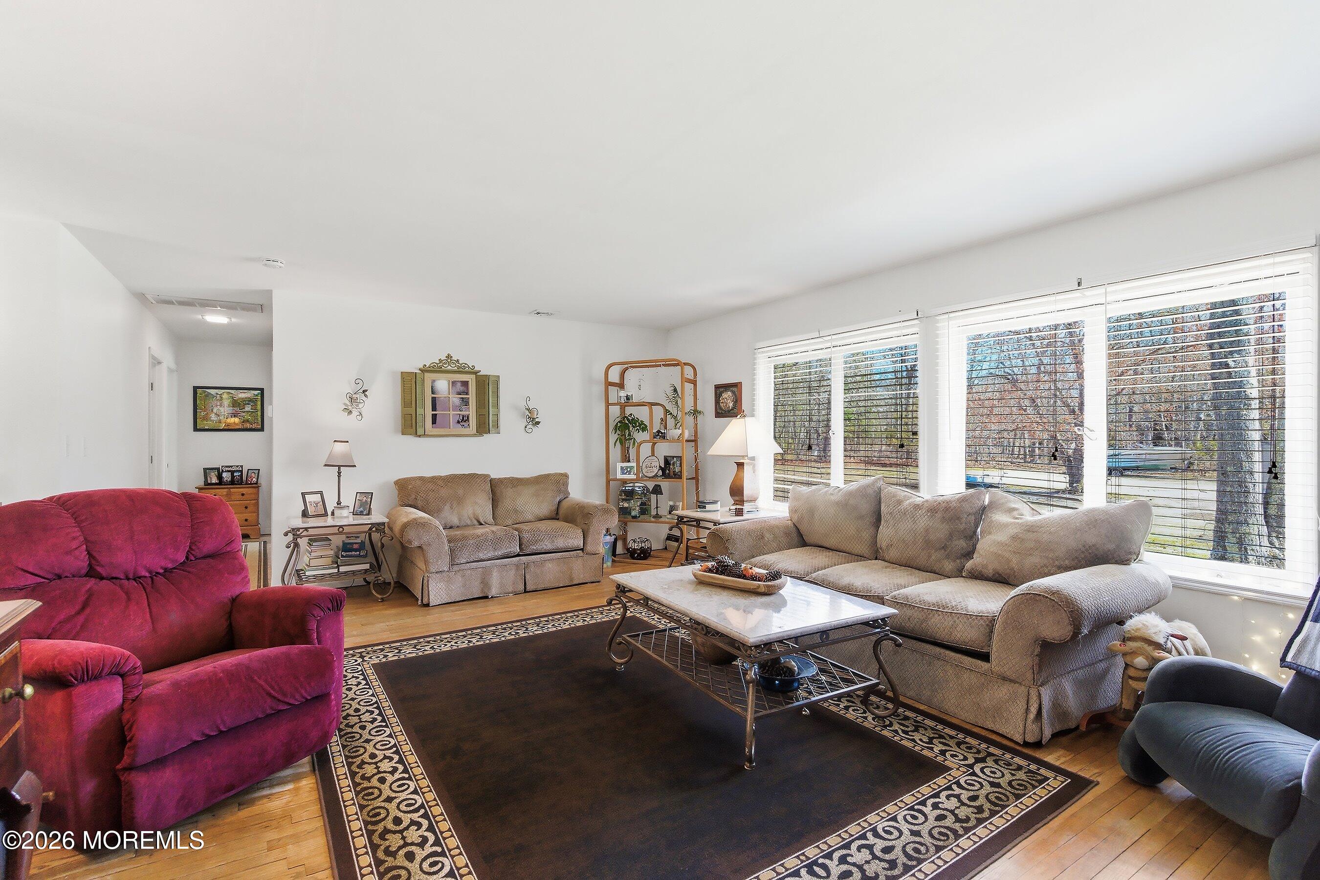 745 Oak Glen Road Howell, NJ 07731 - Photo 11 of 46 a living room with furniture a rug and a large window