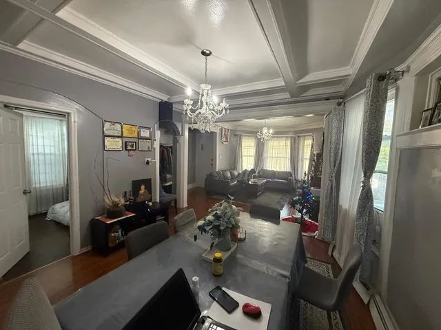a living room with furniture and a chandelier