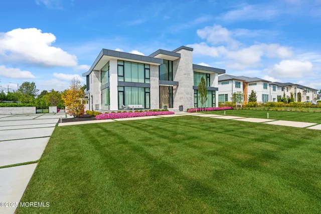 a view of a hallway with wooden floor and a living room