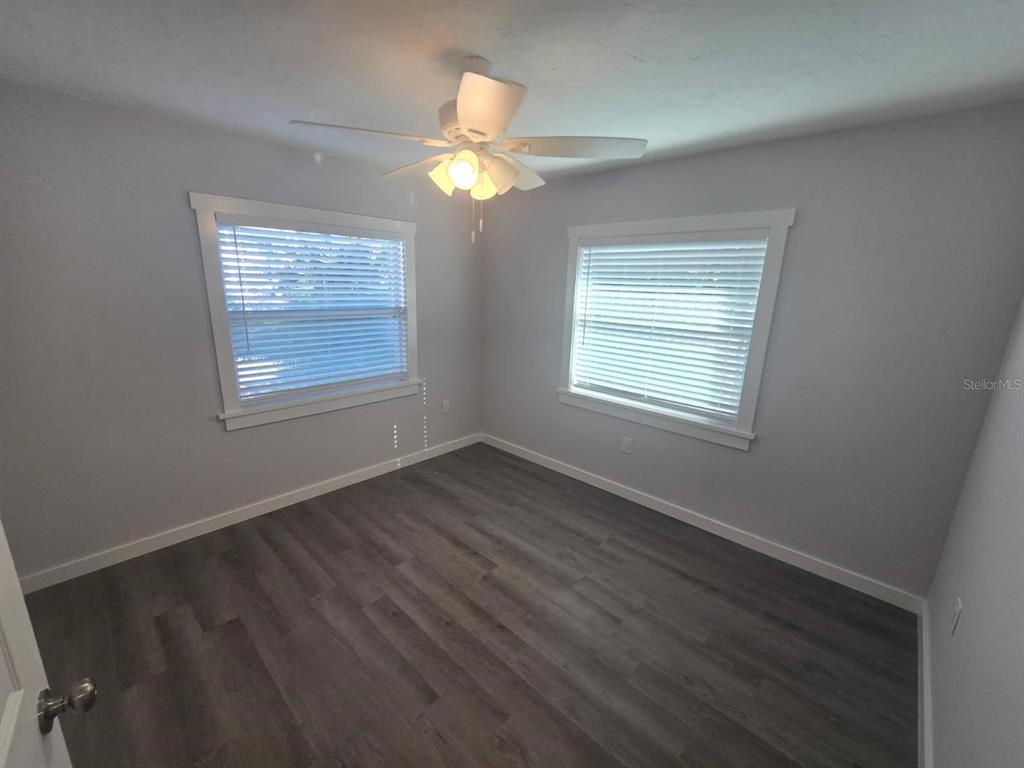 107 29th Street Holmes Beach, FL 34217 - Photo 11 of 13 a view of an empty room with wooden floor and a window