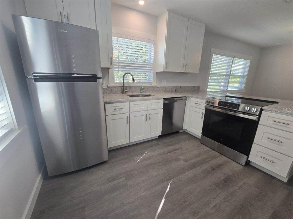 107 29th Street Holmes Beach, FL 34217 - Photo 2 of 13 a kitchen with a refrigerator stove and sink