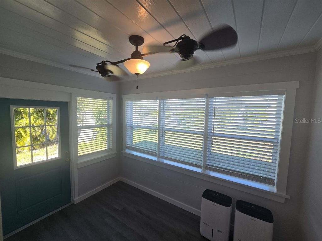 107 29th Street Holmes Beach, FL 34217 - Photo 7 of 13 a view of an empty room with a window and a ceiling fan
