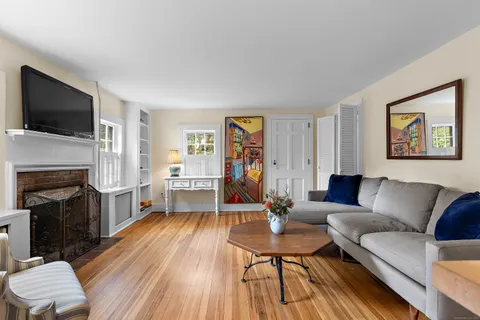 a living room with furniture fireplace and a flat screen tv