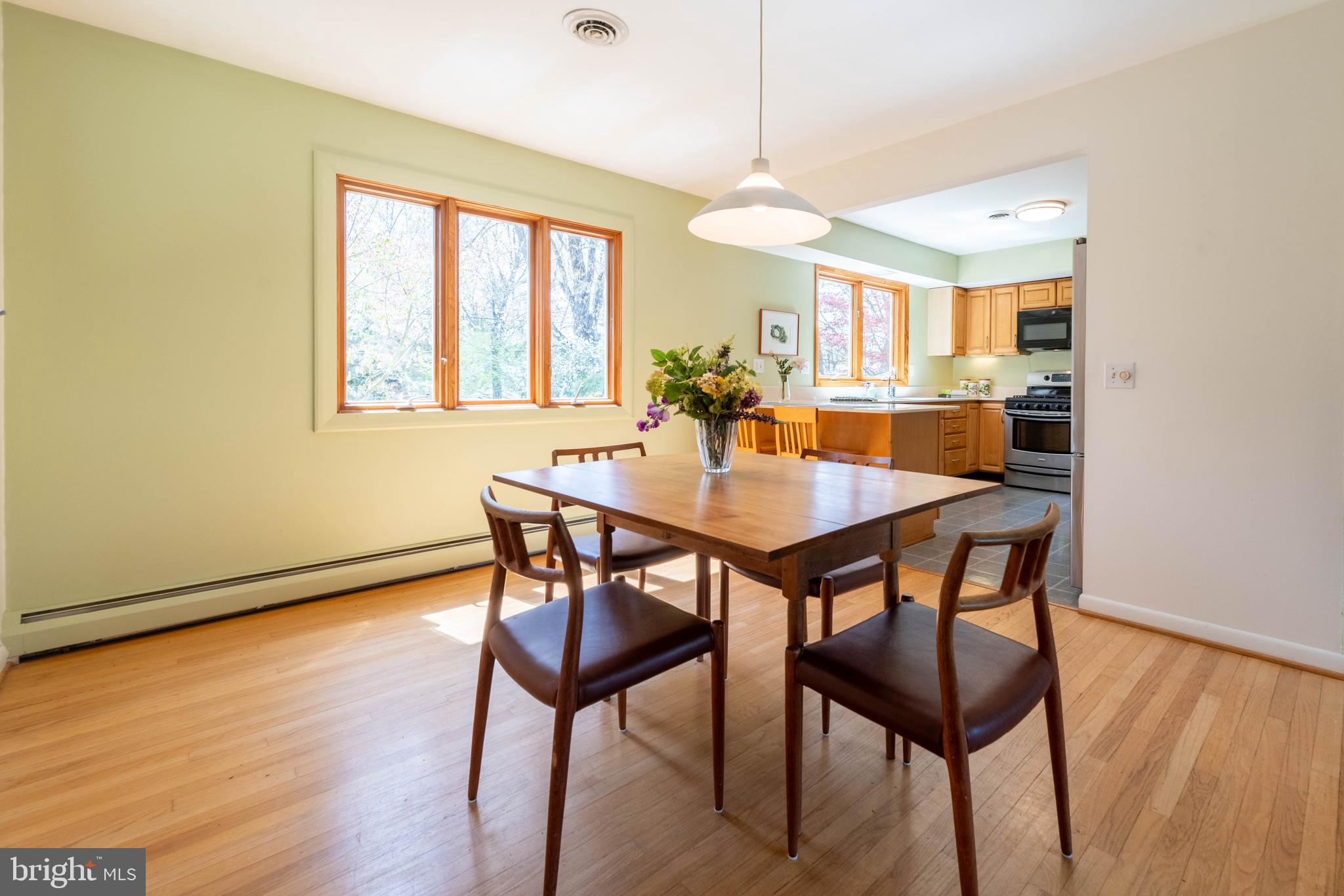 9221 Spring Valley Road Ellicott City, MD 21043 - Photo 12 of 47 a view of a dining room with furniture window and wooden floor