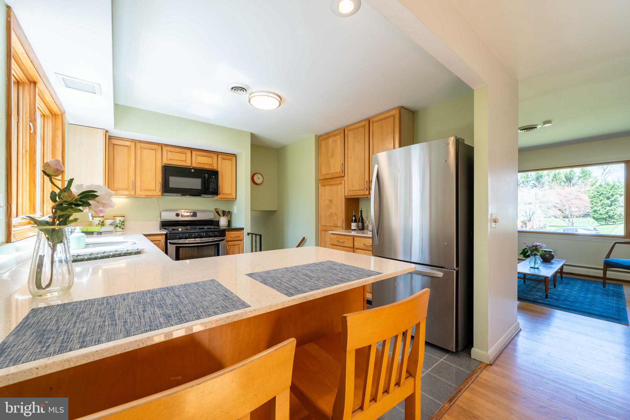 9221 Spring Valley Road Ellicott City, MD 21043 - Photo 15 of 47 a kitchen with stainless steel appliances granite countertop a refrigerator stove top oven a sink and dishwasher