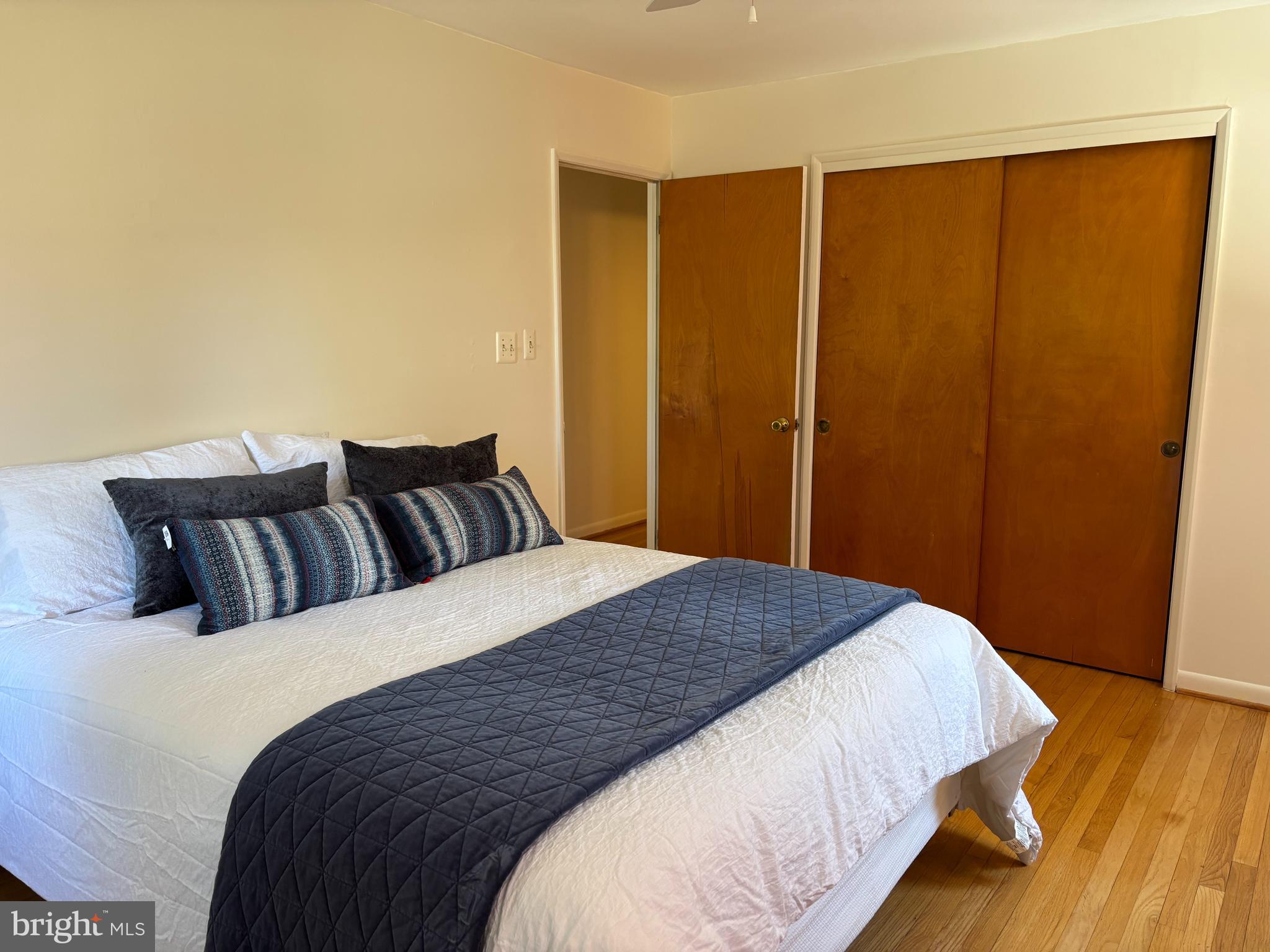 9221 Spring Valley Road Ellicott City, MD 21043 - Photo 21 of 47 a bedroom with a bed and wooden floor