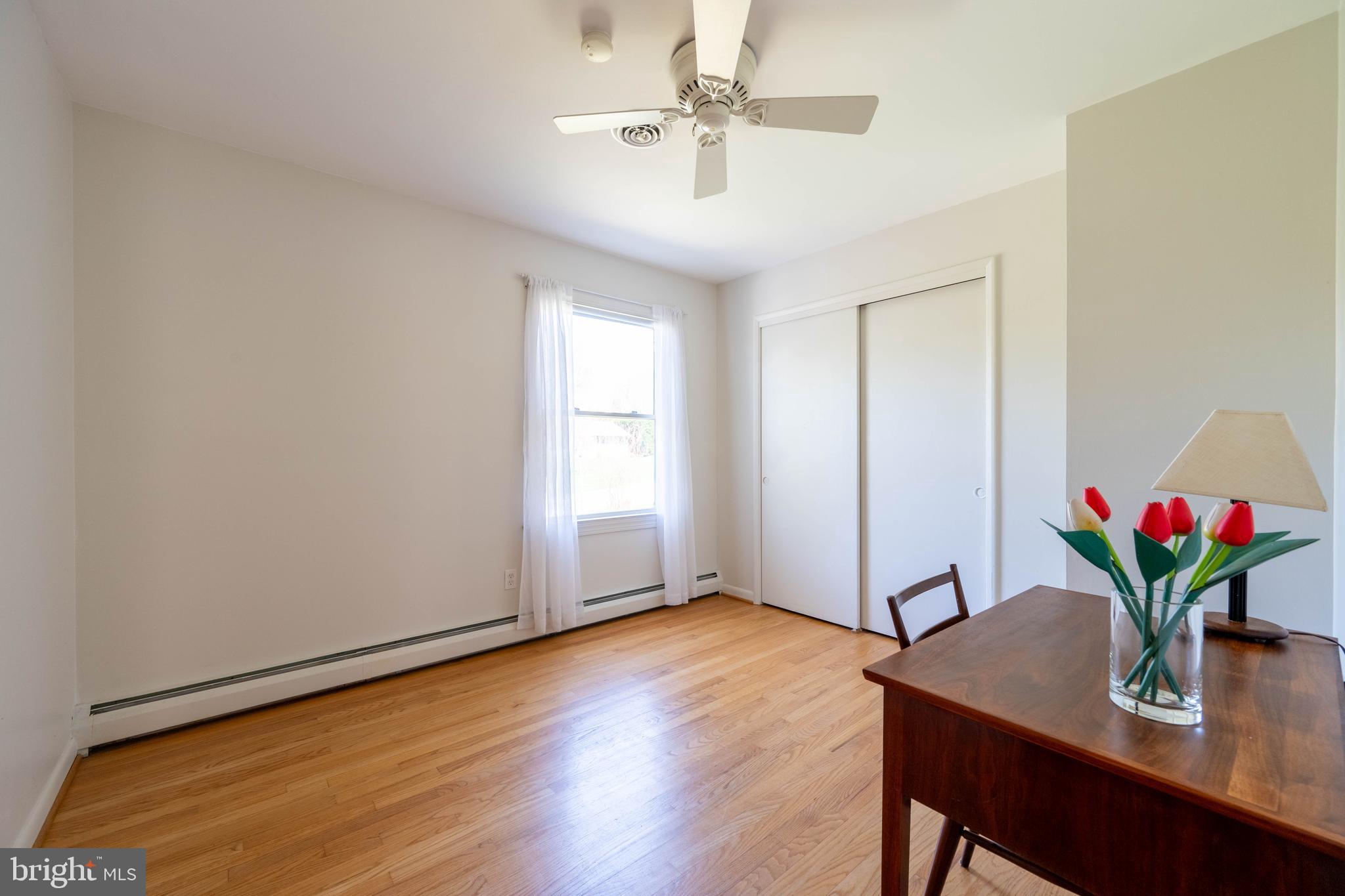 9221 Spring Valley Road Ellicott City, MD 21043 - Photo 25 of 47 a view of a workspace with furniture and wooden floor