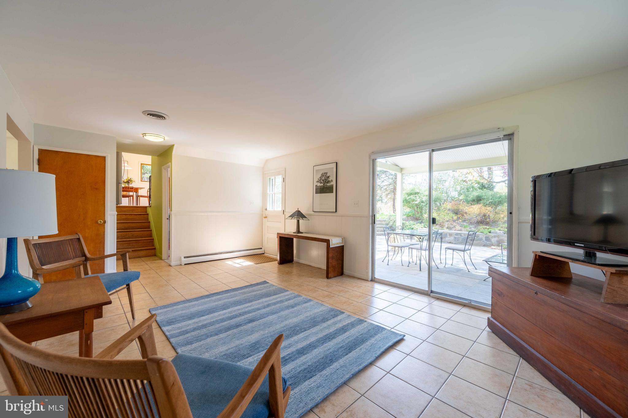 9221 Spring Valley Road Ellicott City, MD 21043 - Photo 31 of 47 a living room with furniture and a flat screen tv