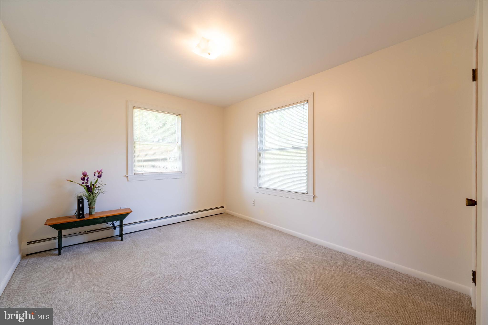9221 Spring Valley Road Ellicott City, MD 21043 - Photo 32 of 47 an empty room with windows and wooden bench