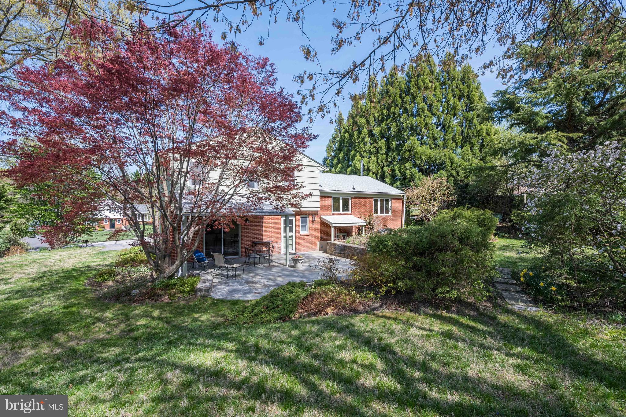 9221 Spring Valley Road Ellicott City, MD 21043 - Photo 41 of 47 a front view of a house with yard and green space