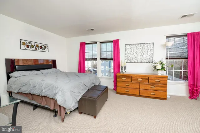 a bed room with a bed and a dresser