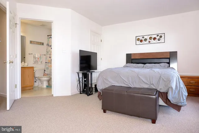 a bedroom with a bed and a tv