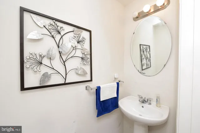 a bathroom with a mirror and a sink