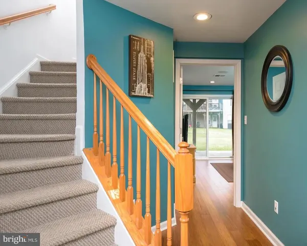 a view of entryway and hall with wooden floor