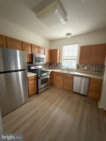 a kitchen with stainless steel appliances granite countertop a refrigerator a stove a sink dishwasher a microwave oven with granite countertops and cabinets