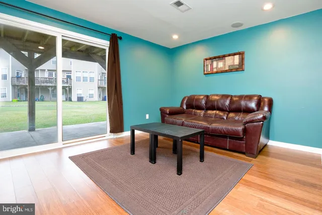 a living room with furniture and a floor to ceiling window