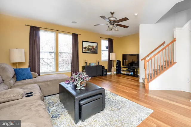 a living room with furniture and large windows